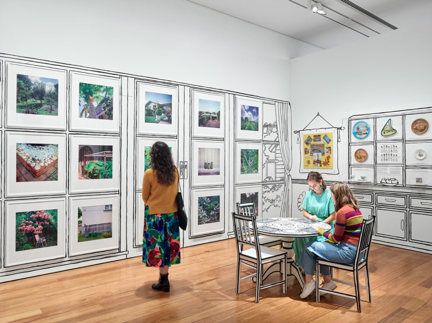 Lady looking at images in exhibition