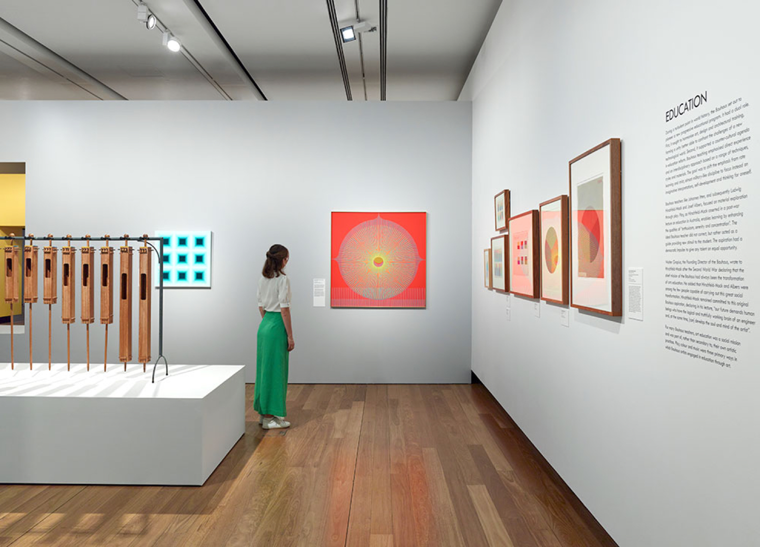 Woman looking at brightly coloured artwork