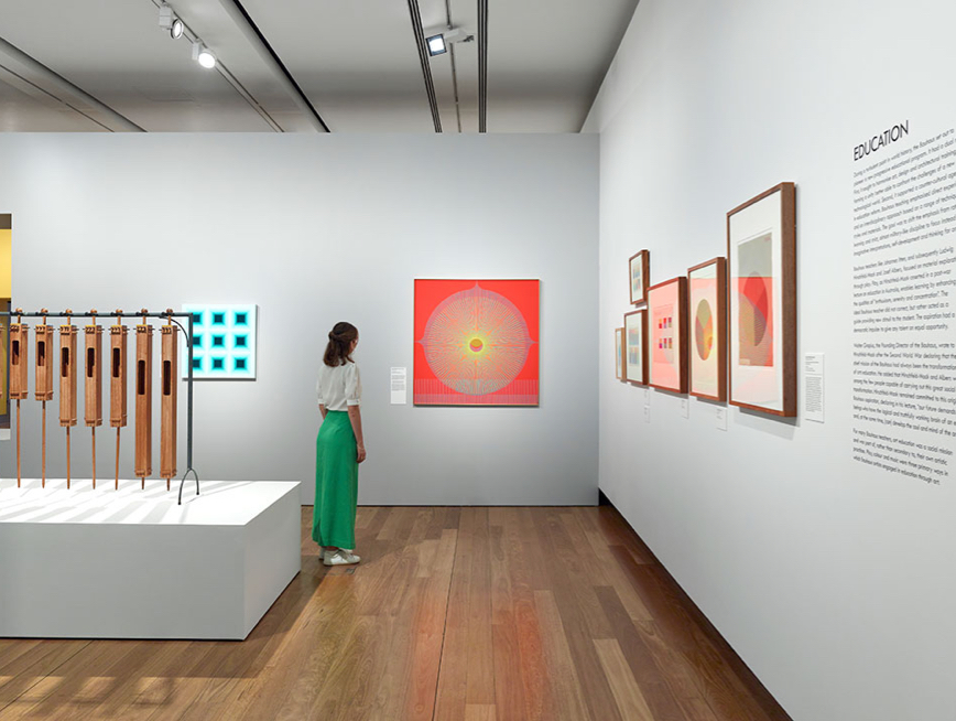 Woman looking at brightly coloured artwork