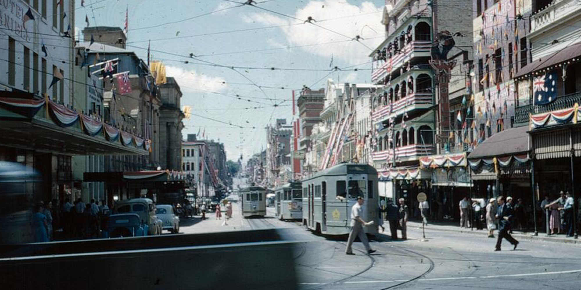 View along Adelaide Street from George Street with the buildings decorated for the Royal Visit, 1954. Courtesy State Library of Queensland.