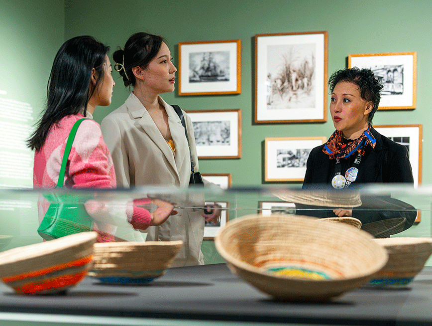 A group of people having a conversation in an art gallery.