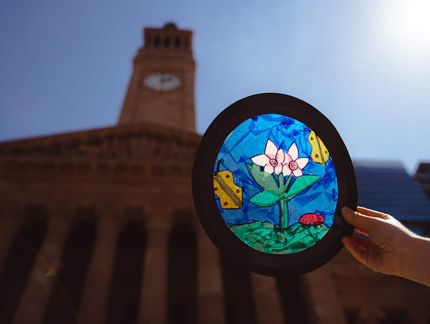 Cellophane and paper 'light catcher' is pictured in the sun with city hall clock tower in the background