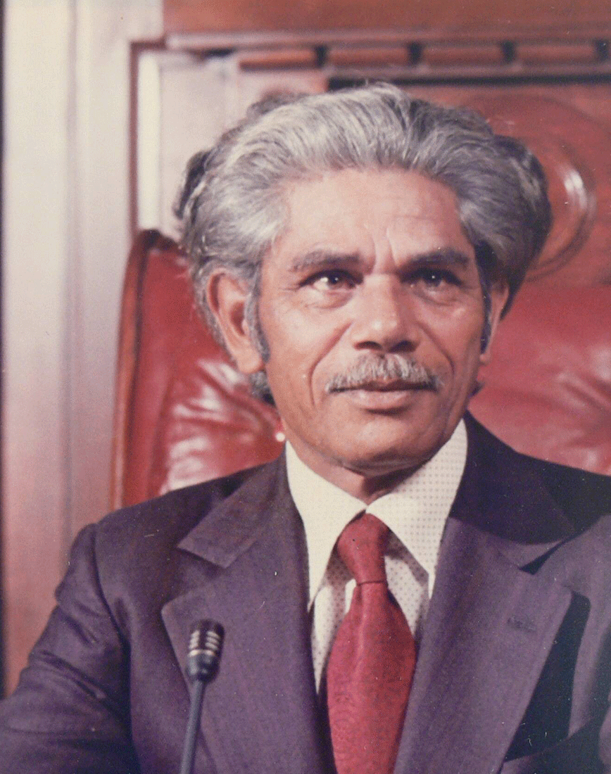 A colour photograph of Neville Bonner sitting in a Senator Chair.