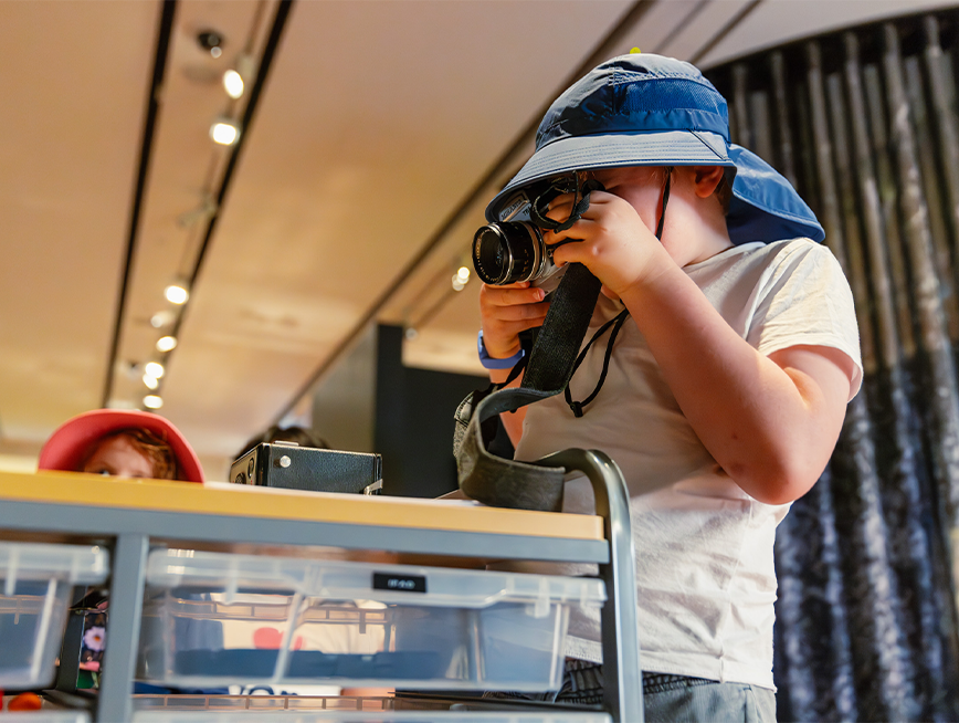 A child looking through a camera.