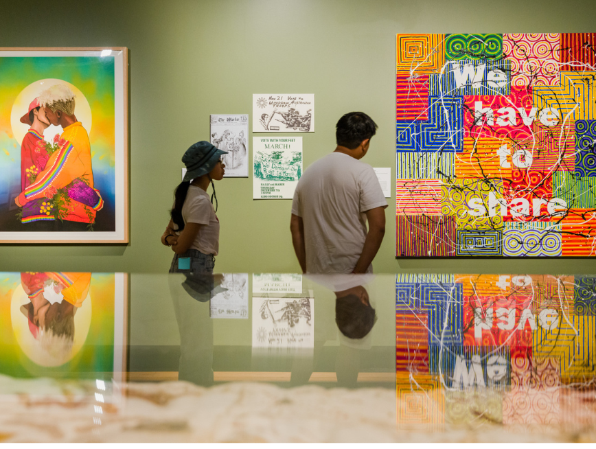 Two people looking at artworks at the gallery.