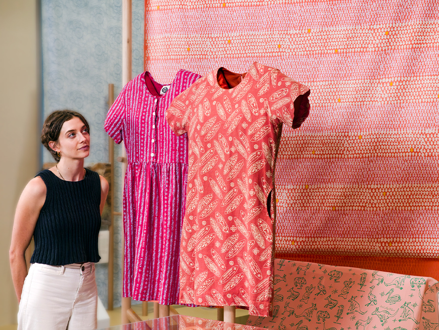 Visitor looking at displayed garments.
