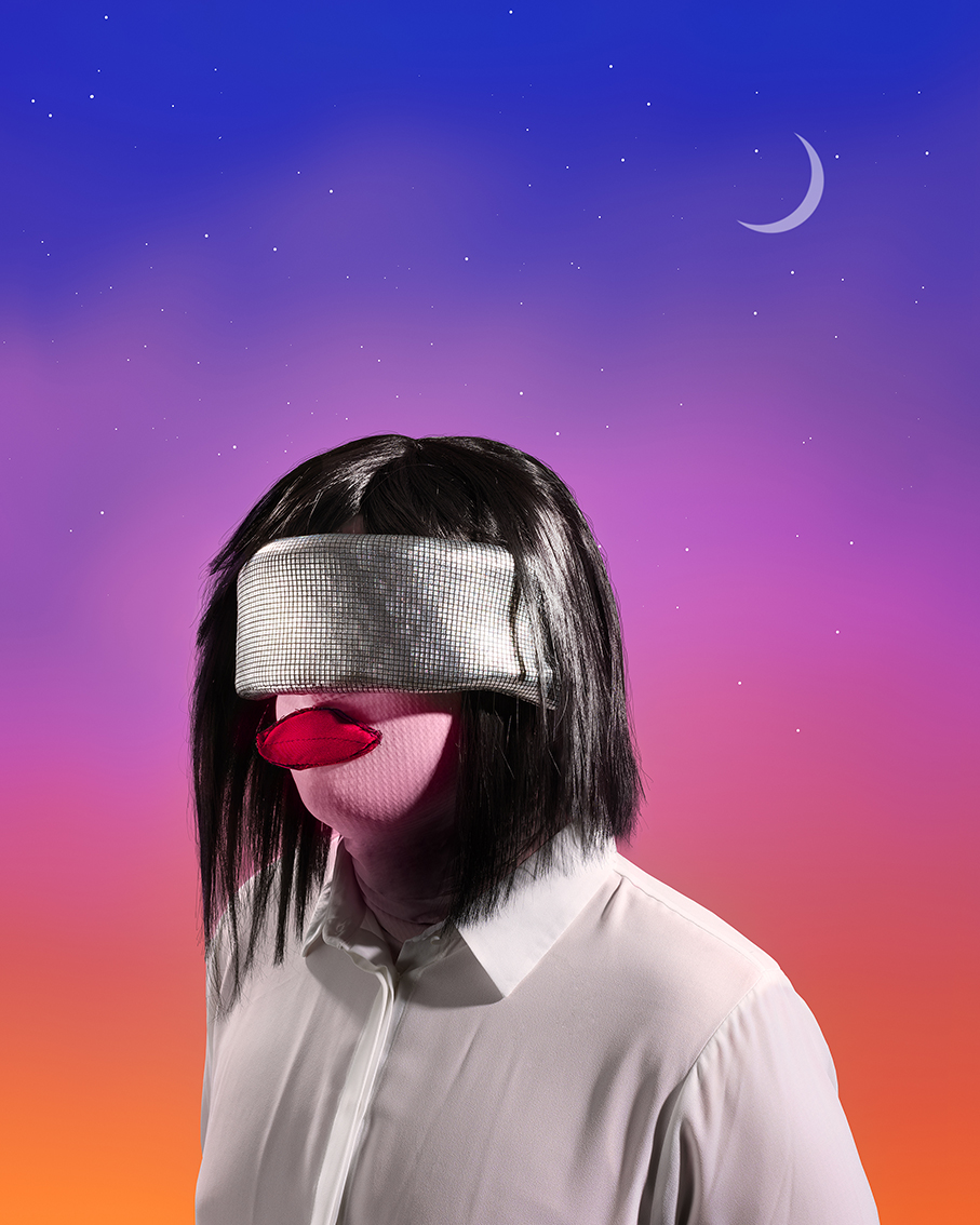 A person in a silver mask with big red lips.