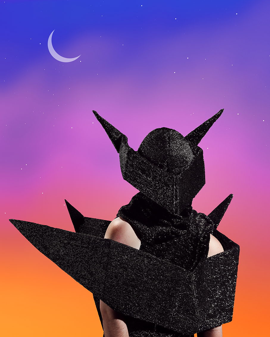 A person in black shimmer sculpture suit.