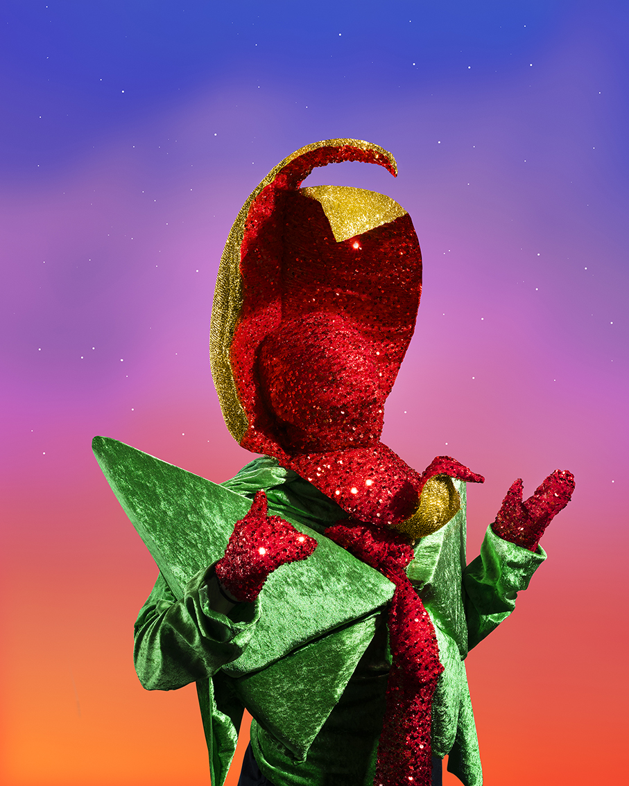 A person wearing a red and blue flower sculpture suit.