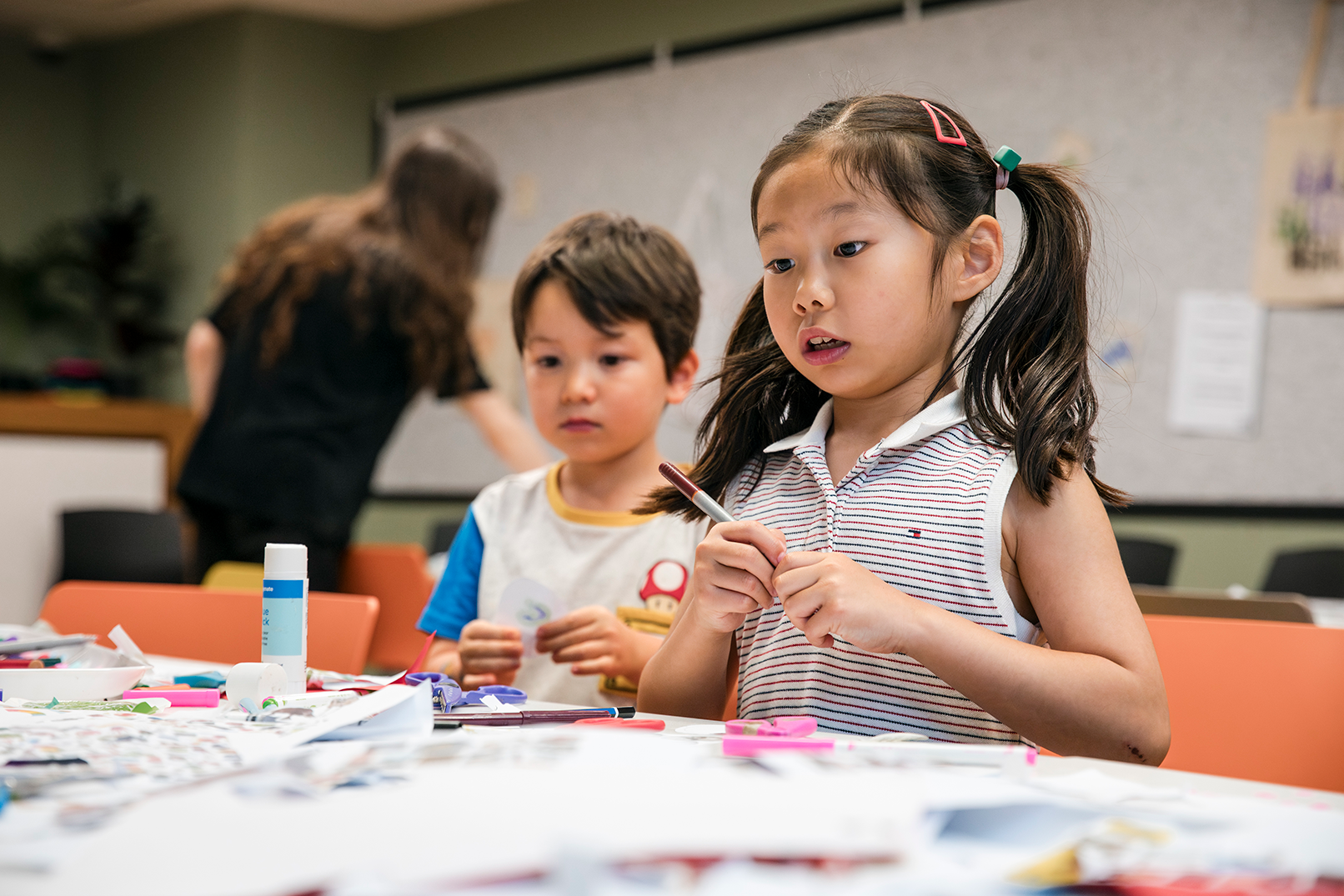 A boy and girl making craft.