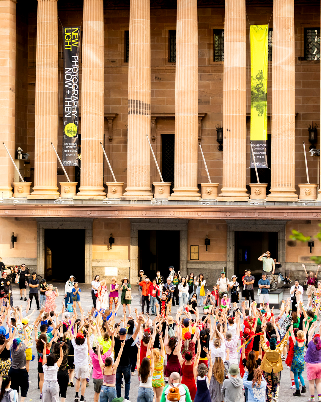 100 and more participants at King George Square Showdown. The participants are following the dance moves of the lead dancer.