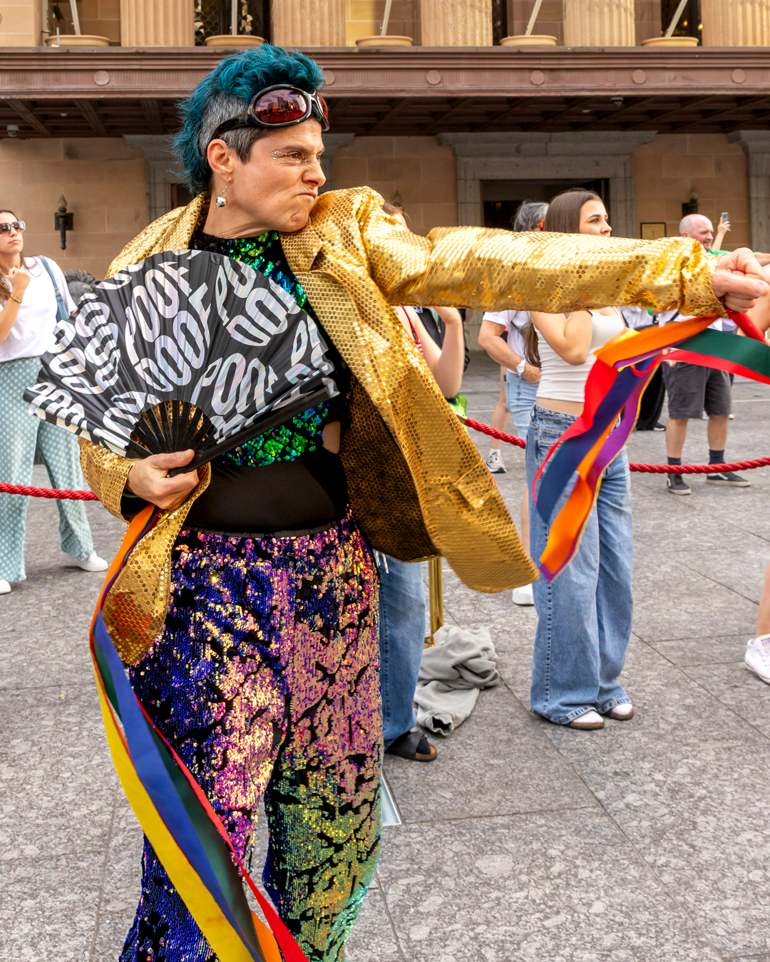 A person wearing colourful clothes, dancing.