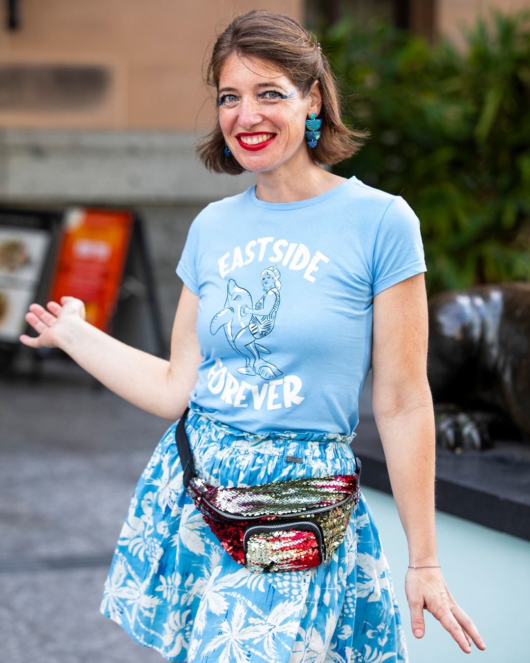 A woman in blue posing in front of the camera.