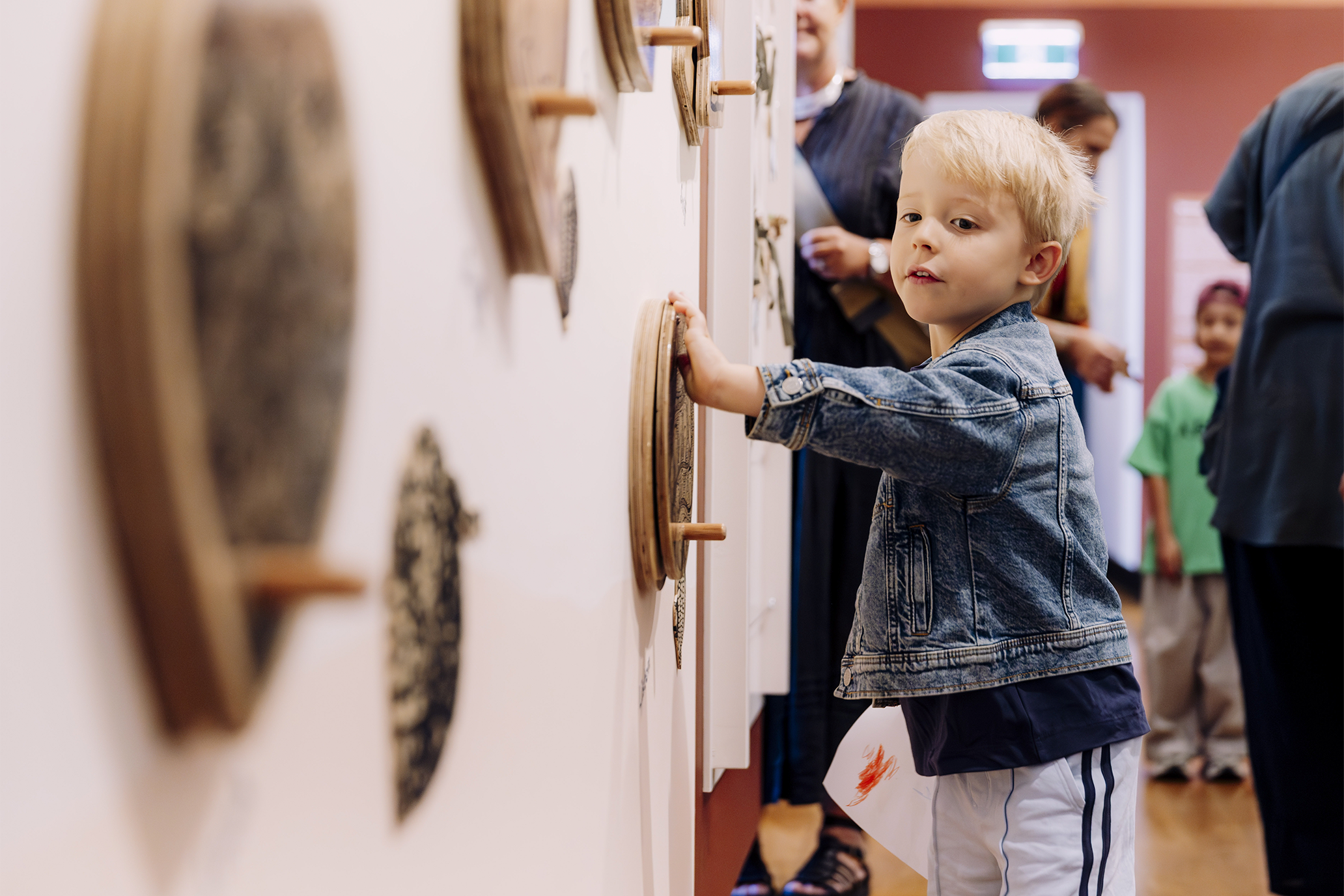 A young boy touching the interactive wall.