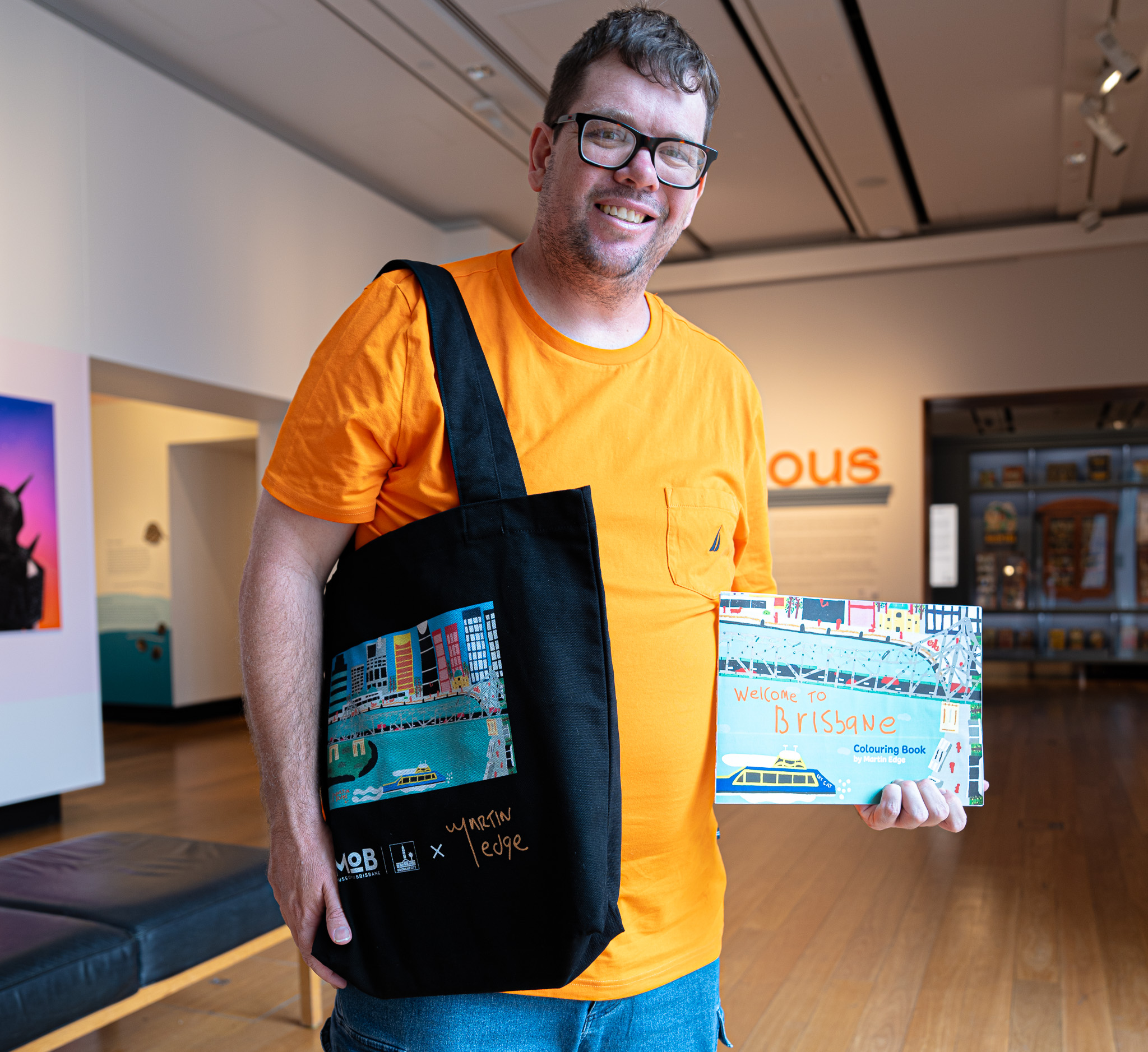 Martin Edge and his new book Welcome to Brisbane and MoB Members tote bag. Photo: MoB.