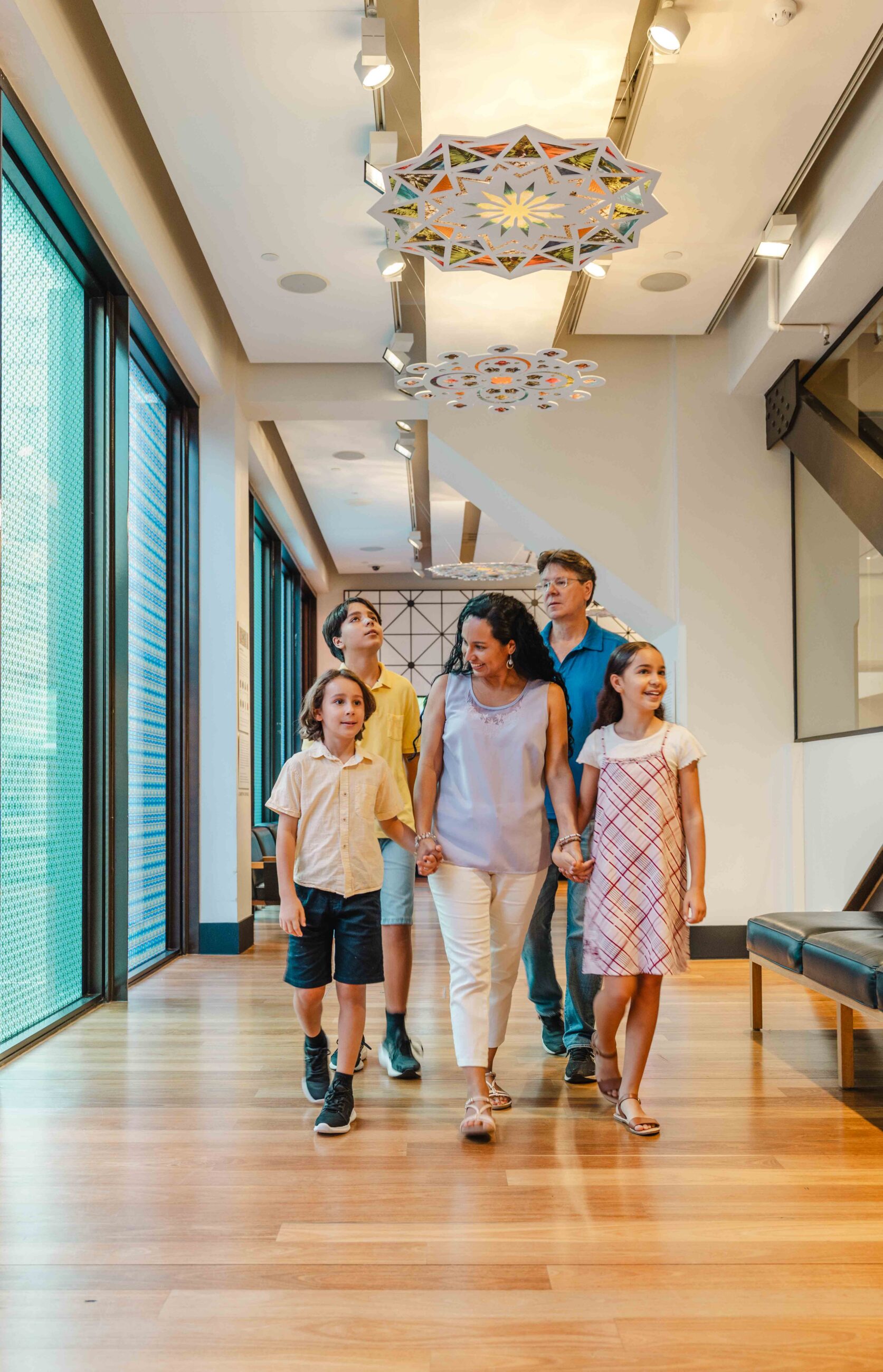 A family of four walking towards the camera.