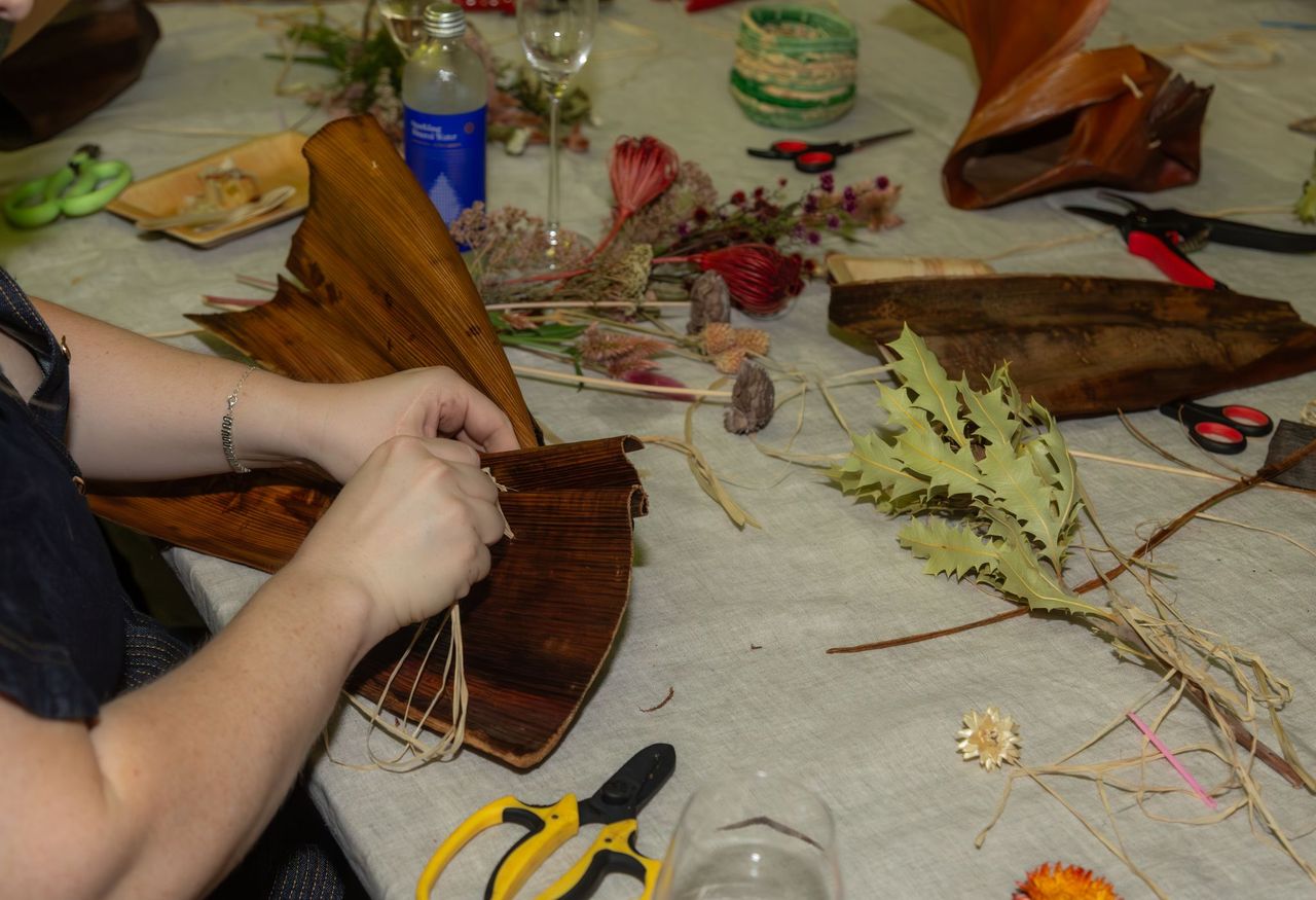 hands wrapping a coconut husk with string