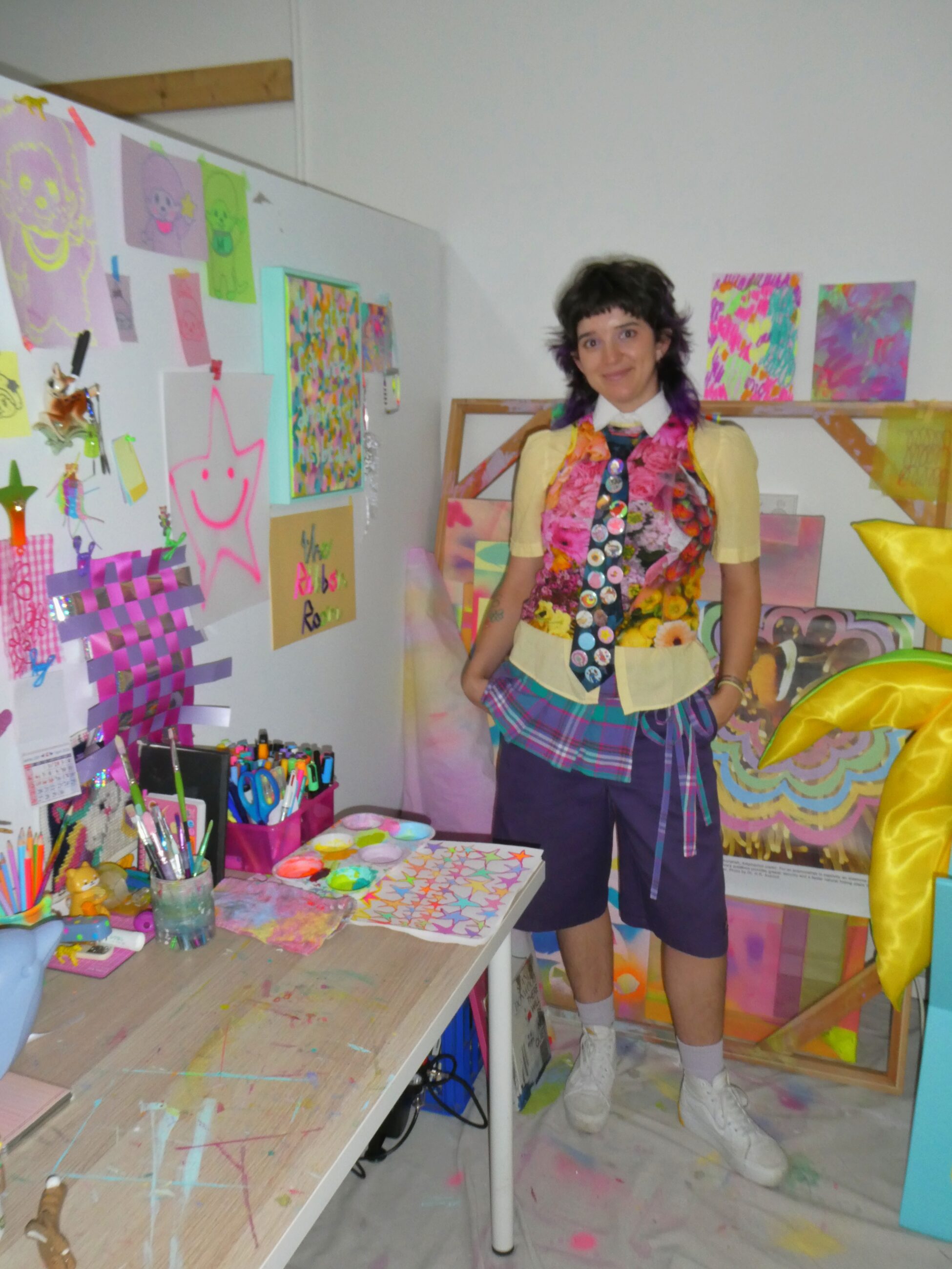 Artist posing in their studio wearing a unique outfit