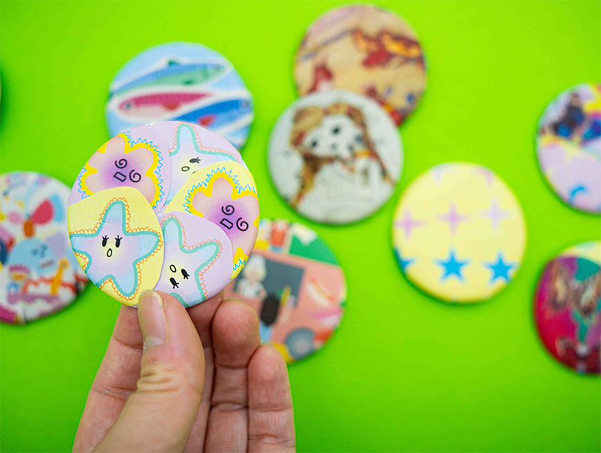 Badges with abstract art displayed on them