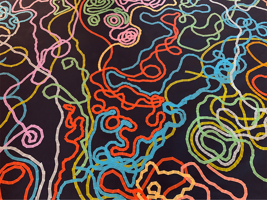 Colourful lines made of tapes on the dark colour floor.
