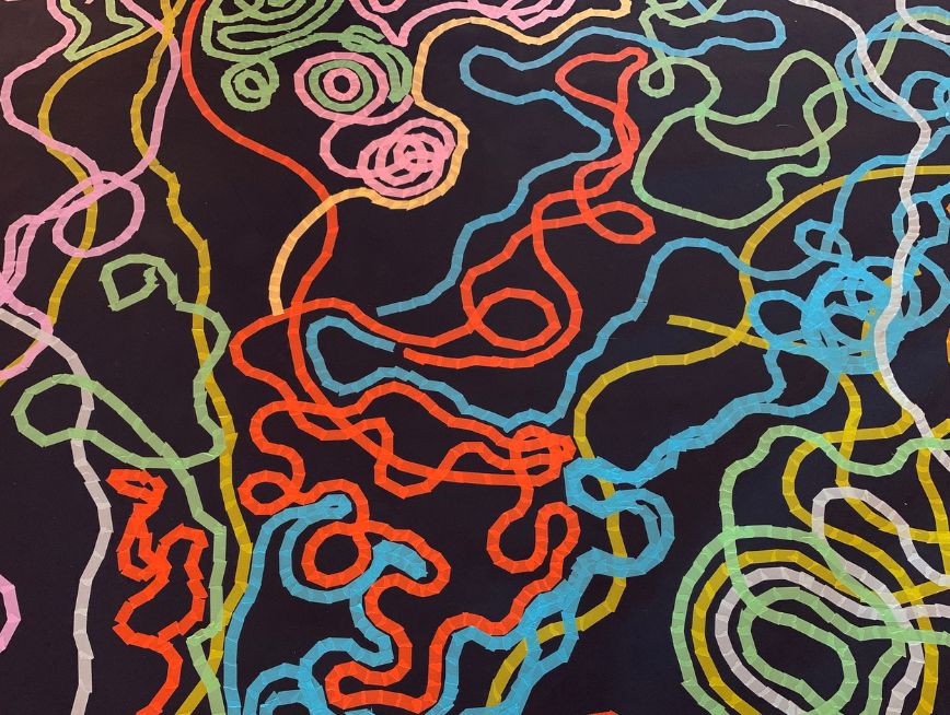 Colourful lines made of tapes on the dark colour floor.